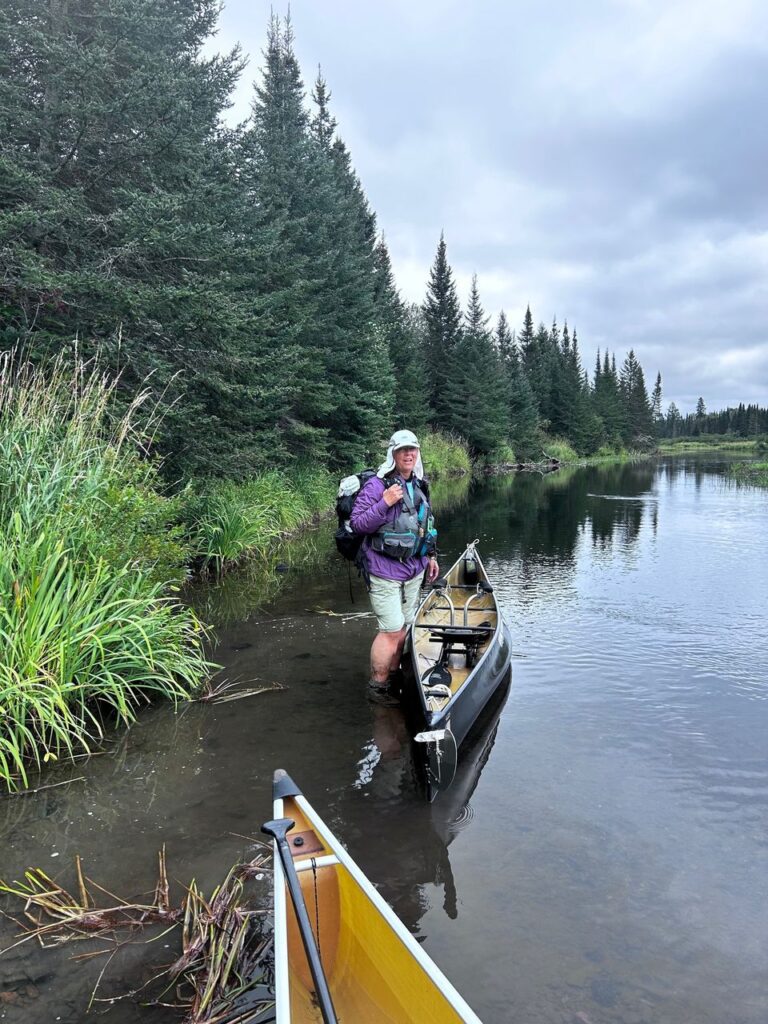 Kris with her canoe in the Pigeon River in Northern Minnesota