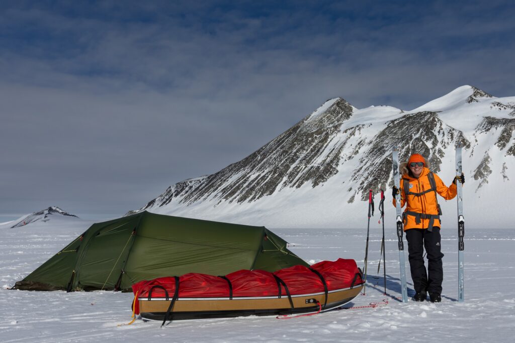 Andy with her tent and loaded sled