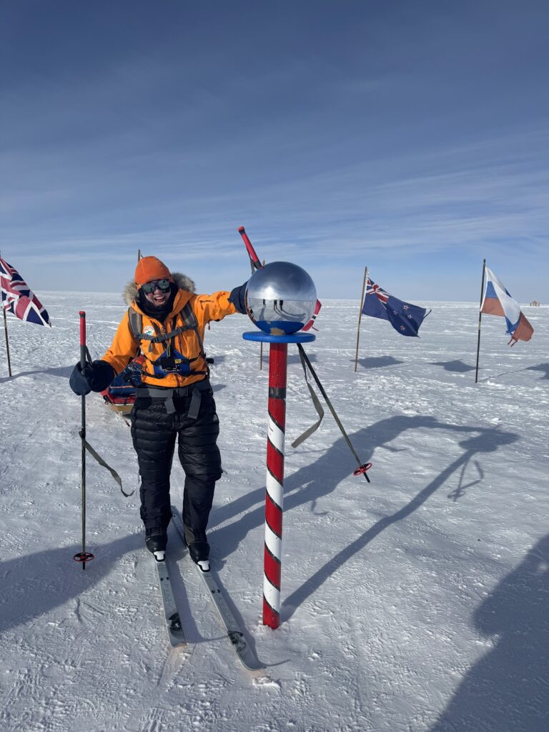 Andy touching the South Pole at the completion of her 55 day journey