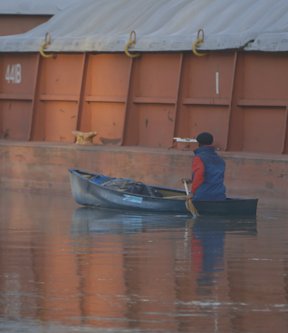 Eddy canoeing past a Mississippi River Barge