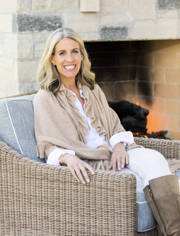 Jane Saccaro sitting by the fireplace