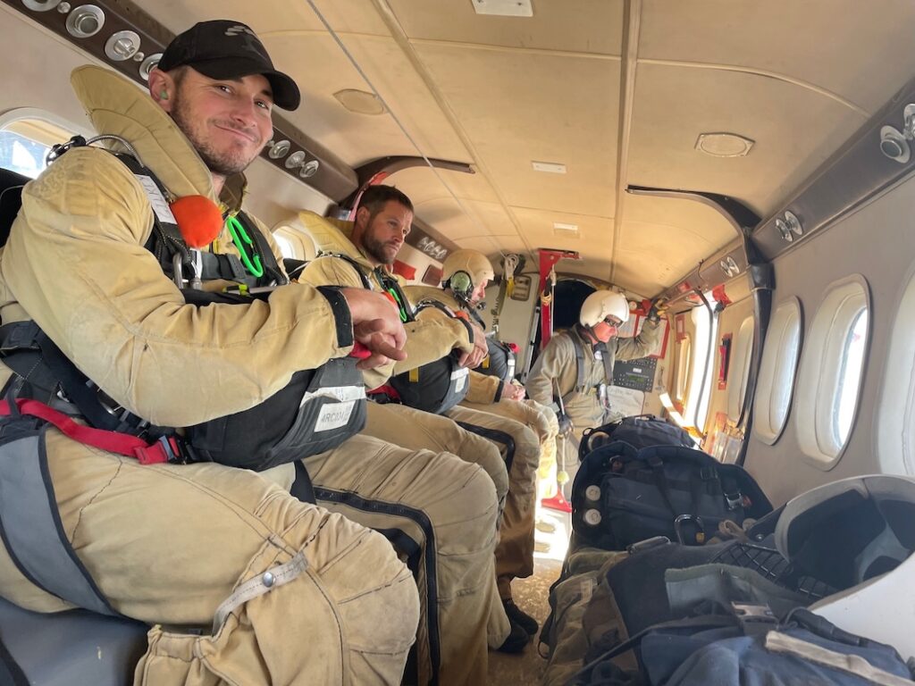 Smoke jumpers in the plane ready to jump
