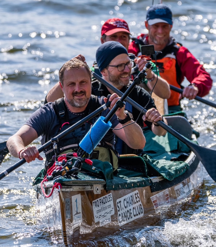 The 4-man paddling crew aboard their canoe for the Mississippi River Speed Record