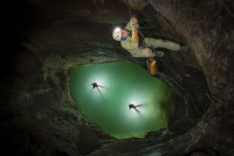 Looking down into a deep cave pool