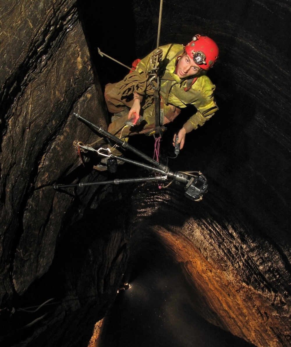Robbie descending a deep cave shaft
