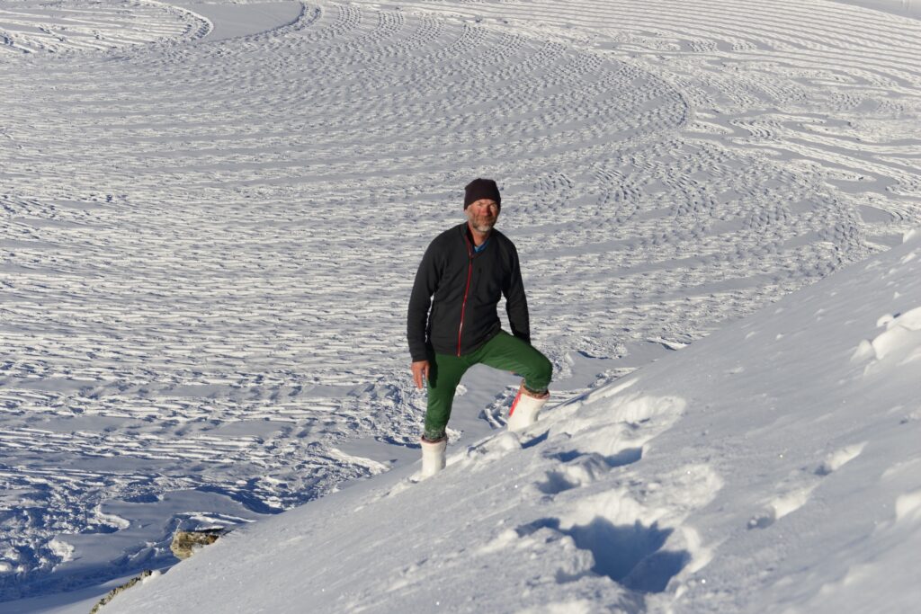 Simon posing by his snow drawing