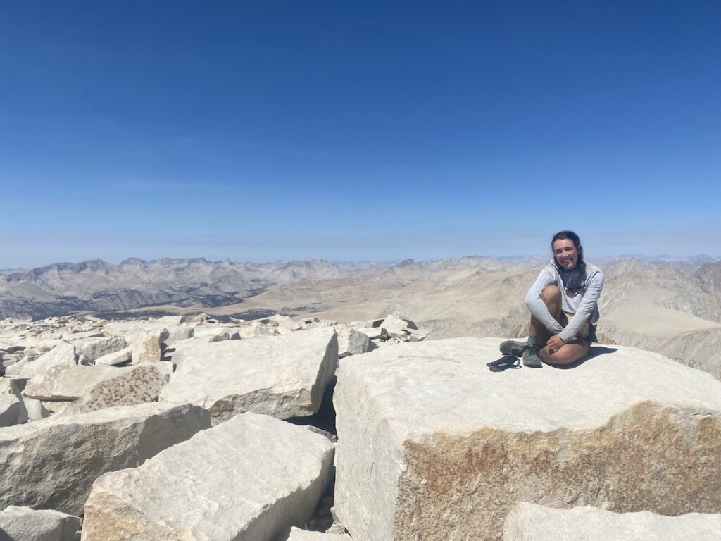 Grace sitting atop giant rocks