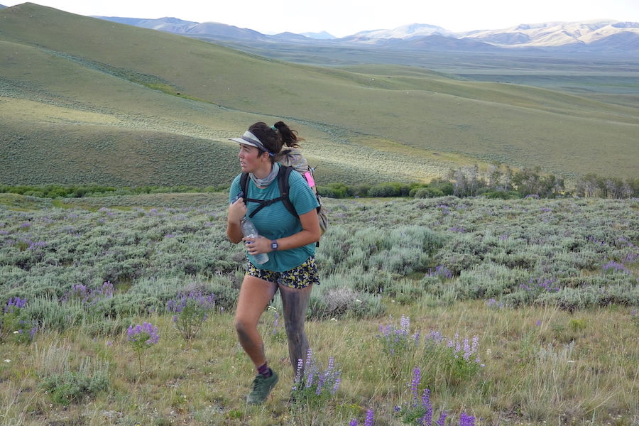 Grace hiking through a mountain meadow