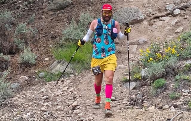 Peter in bright garb coming down a rugged trail on the Leadville 100