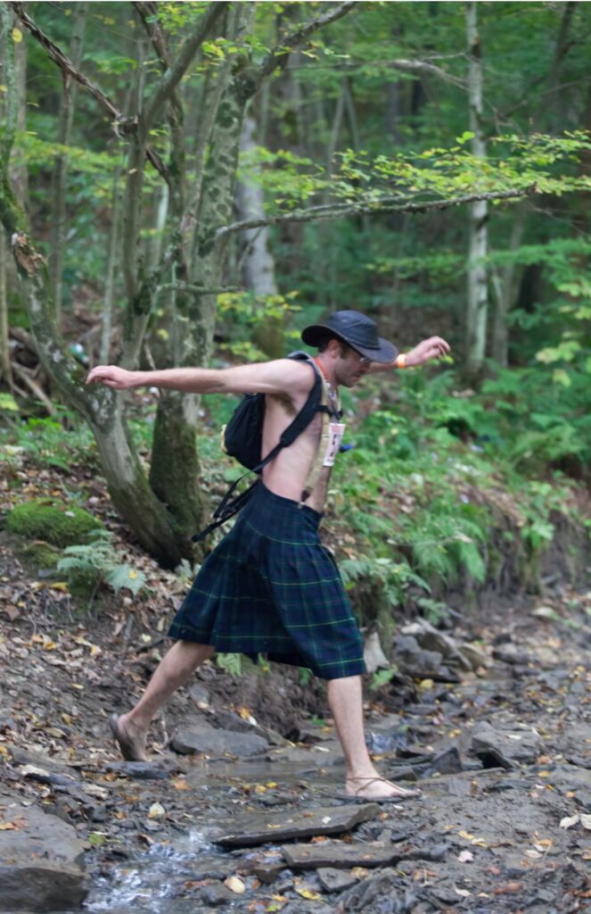 Peter trail running in his signature kilt and sandals.
