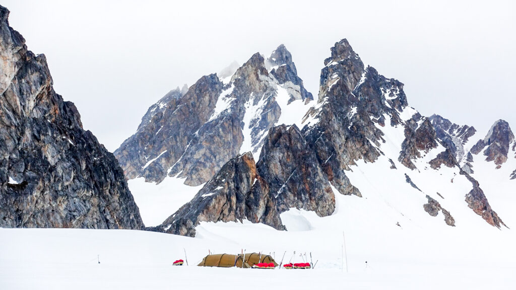 Tents with mountains in the background.