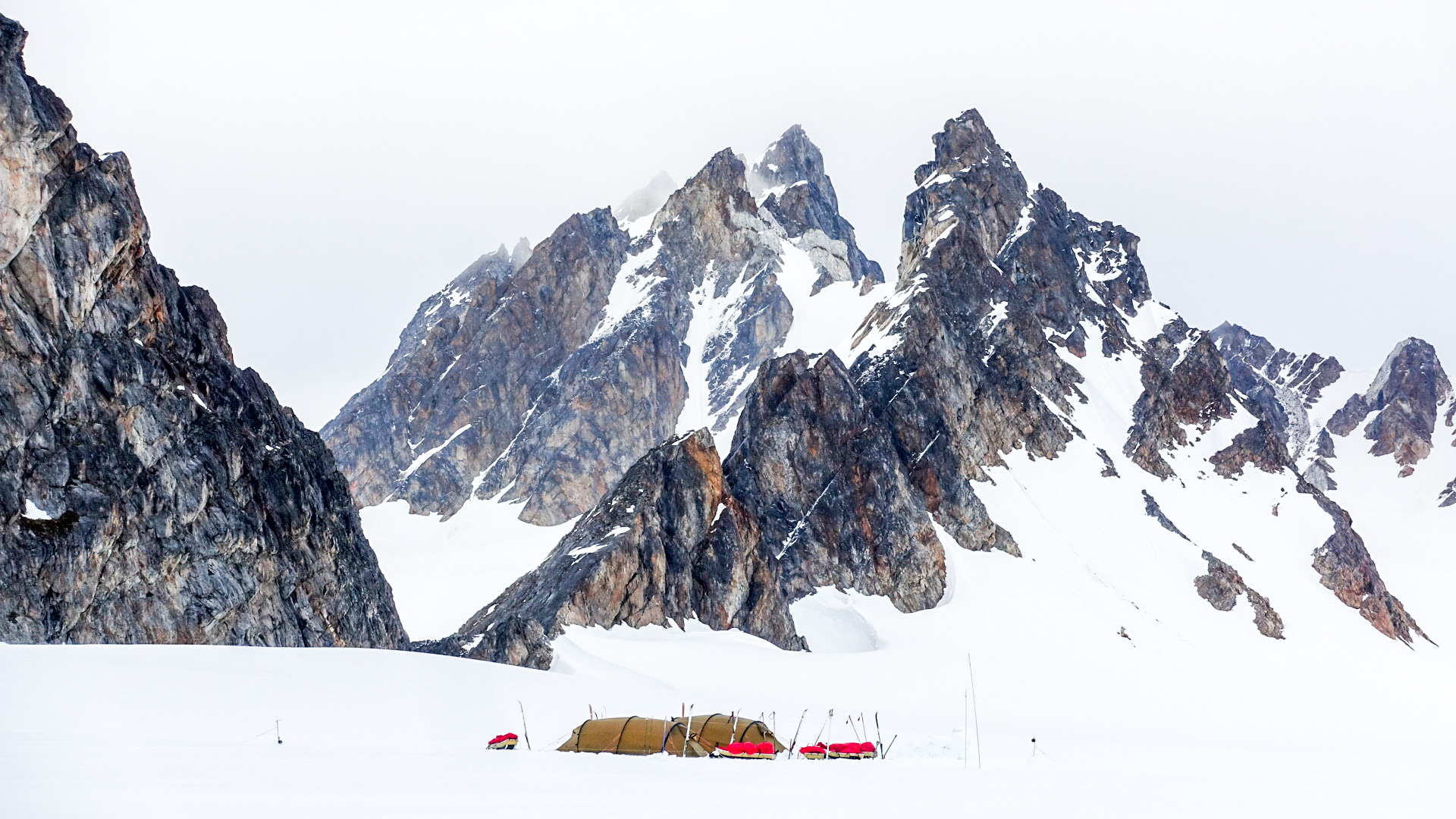 Tents with mountains in the background.