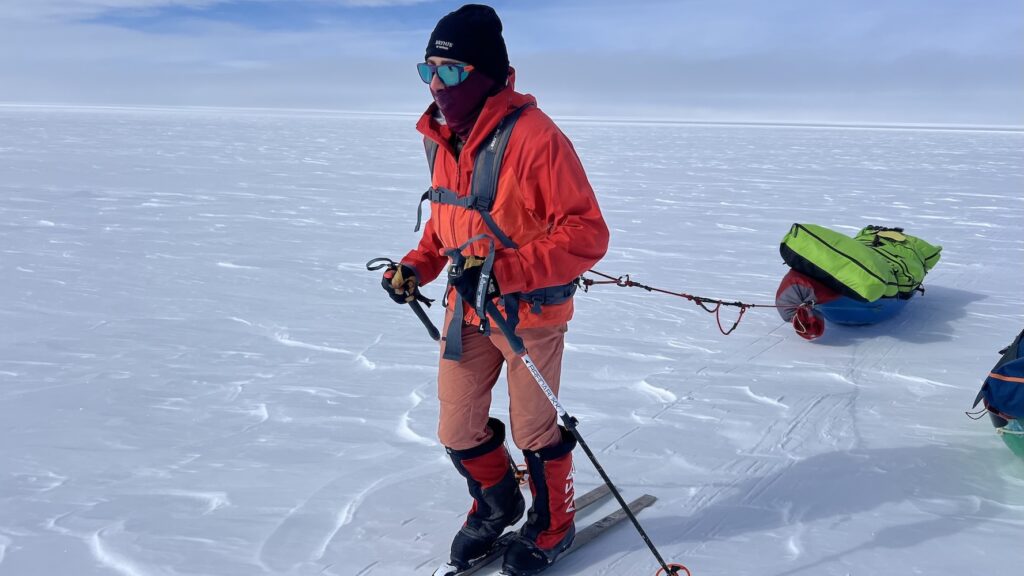 Andrea pulling her sled across endless wind-swept snow