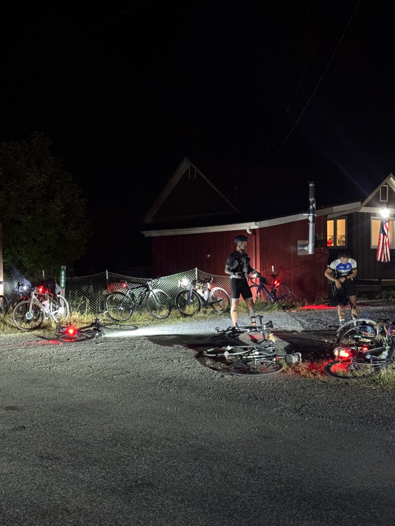 Cyclists at a rest stop in the dark