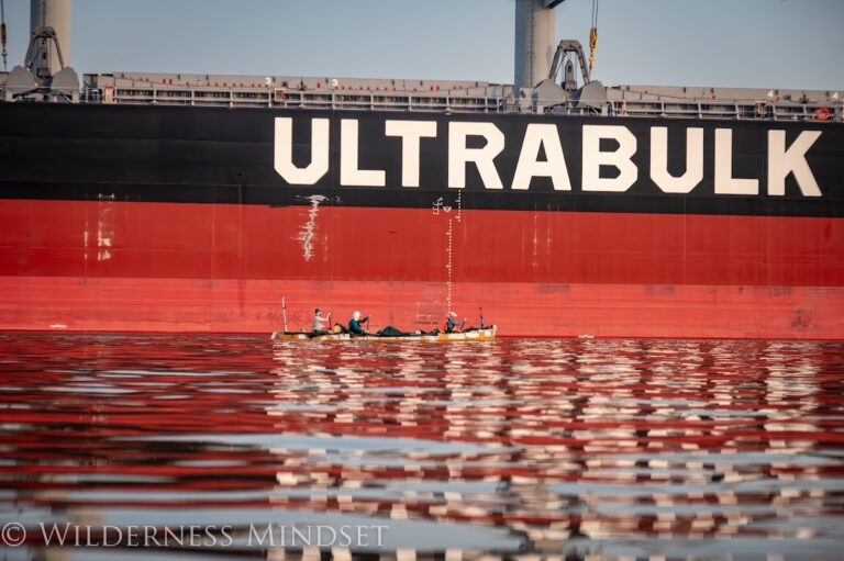 The canoe alongside a giant bulk carrier on the lower Mississippi