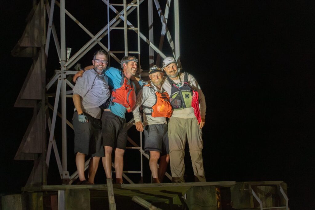 The 4 guys who broke the Mississippi River speed record standing on the river's Mile Post 0 buoy