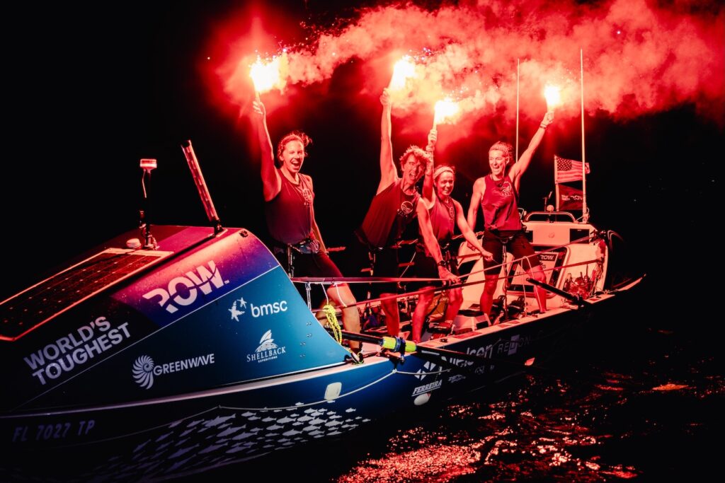 The 4-person rowing team celebrating upon their Atlantic crossing finish