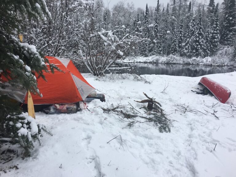 Dianne's campsite in the snow with her red canoe