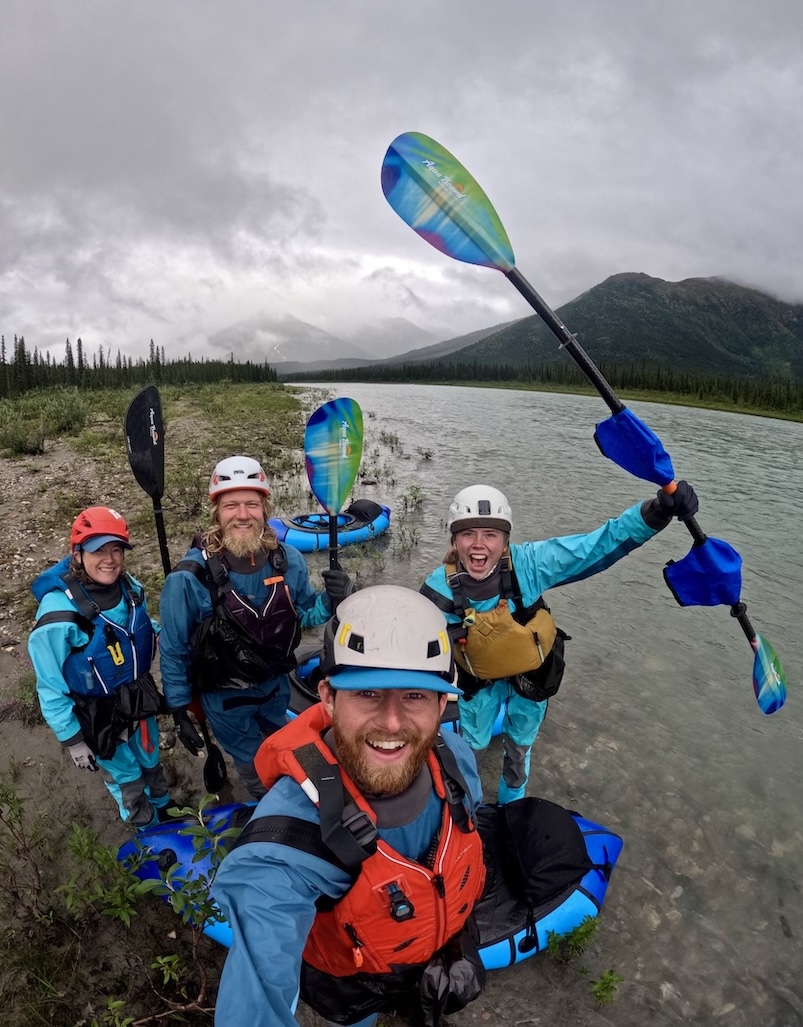 The packrafter group in all their gear along the river