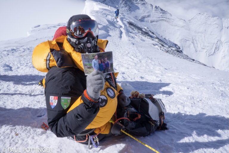 Paul on Mt. Everest holding a photograph of his family