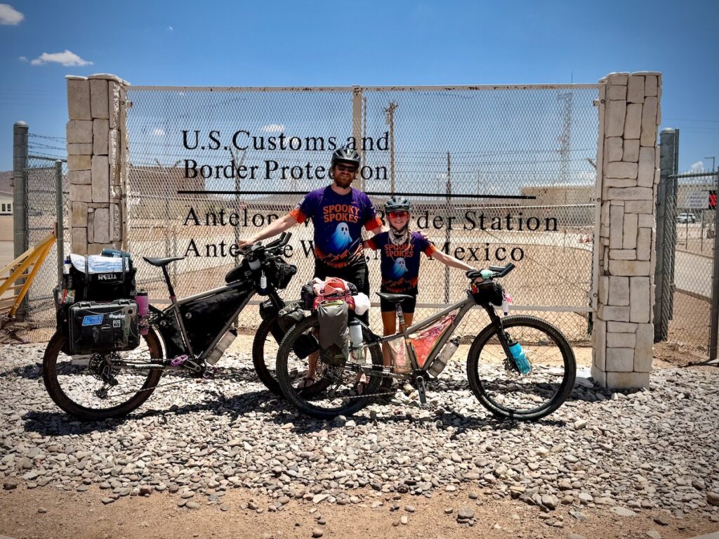 Molly and her dad with their bikes at the Mexican border