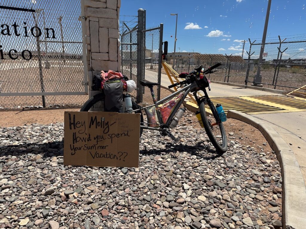 Molly's bike with a sign that reads, "Hey Molly, how'd you spend your summer vacation?"