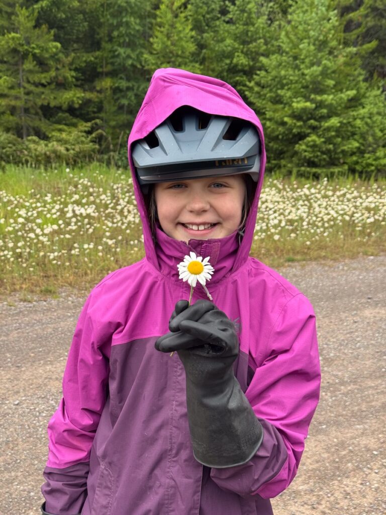 Molly holding a flower and smiling