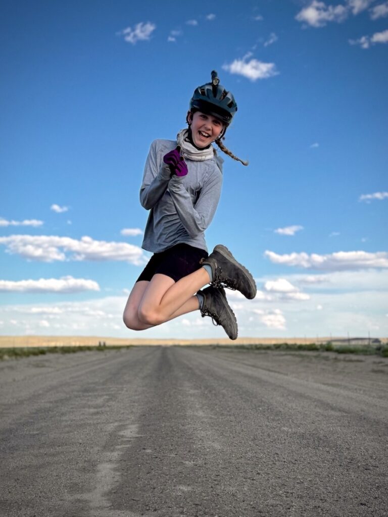 Molly leaping in the air and smiling
