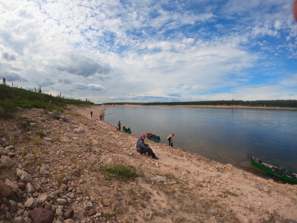 Arctic river with canoers resting on the bank