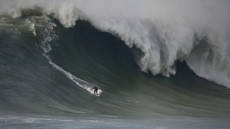 Surfer on the face of a giant wave at Mavericks