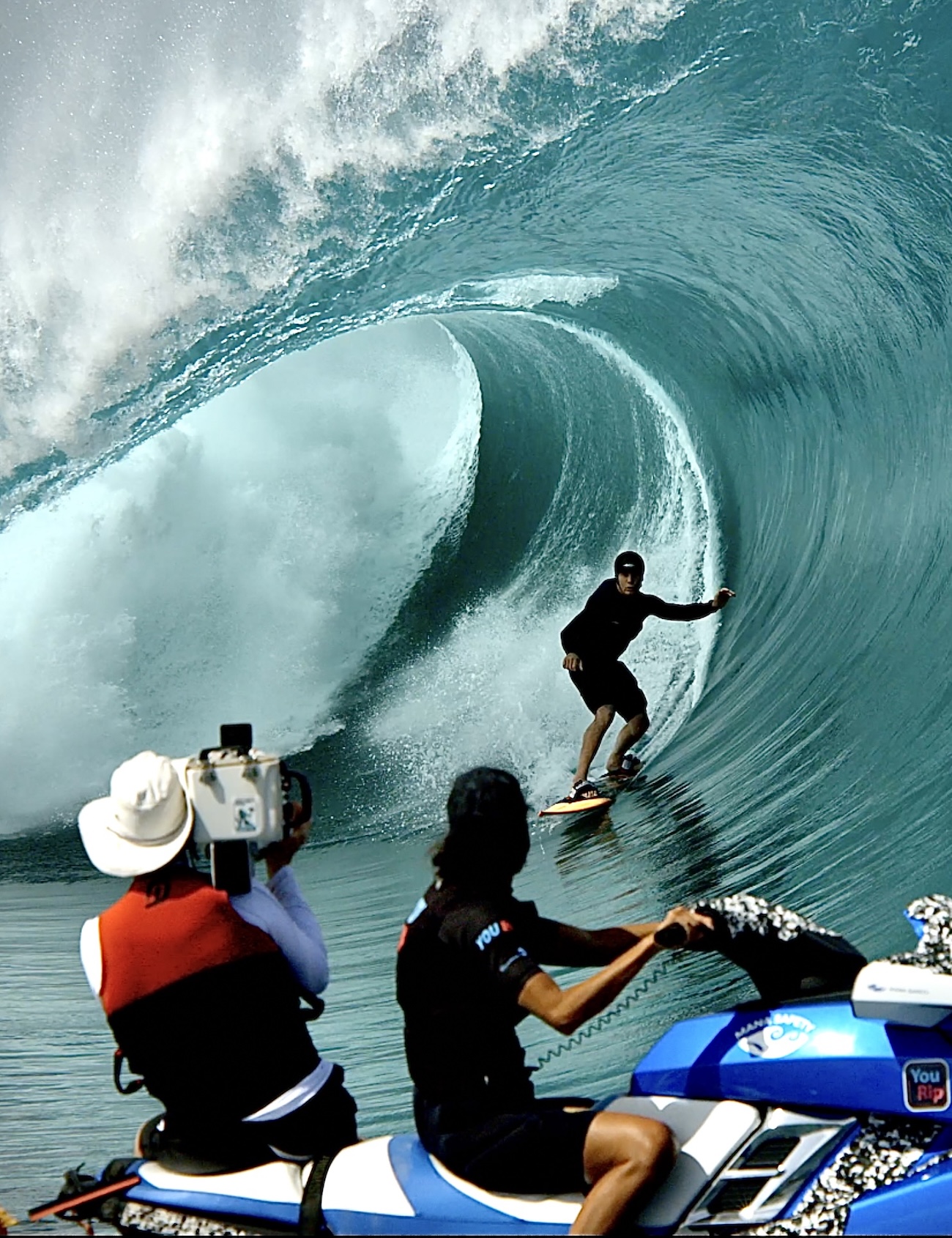 Tim on a jet ski filming a surfer barreling towards him