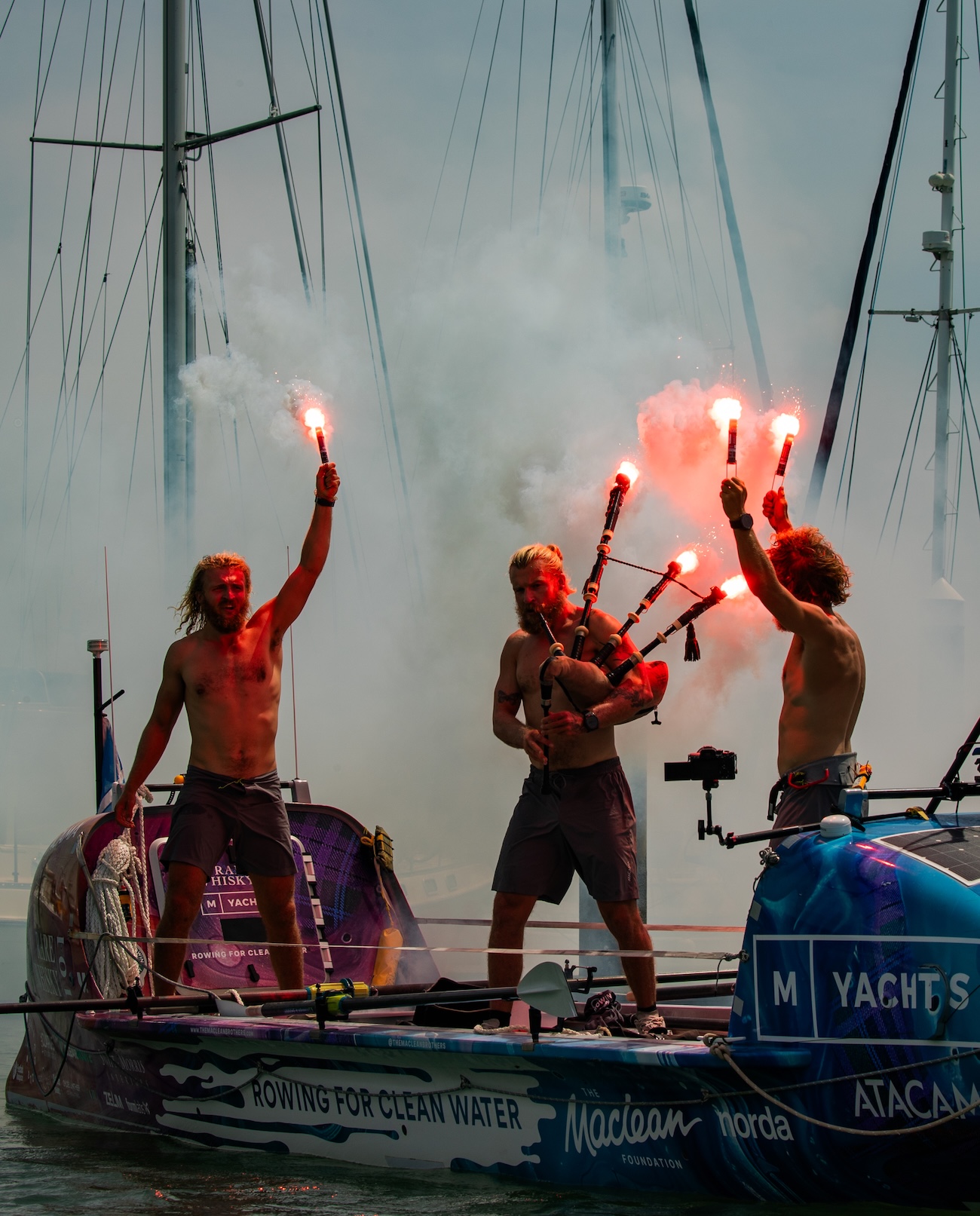 Maclean brothers celebrating their finish with lit flares and bagpipes