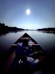 The moon rising over the canoe as my canoe-mate takes a nap